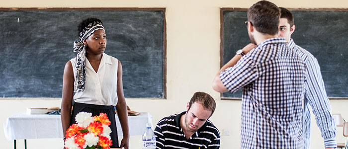 ACE Sierra Leone students examining a blackboard
