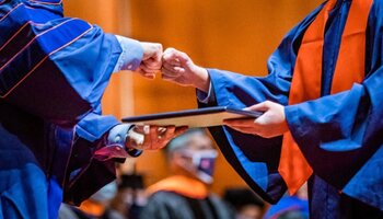 Student accepting diploma at graduation